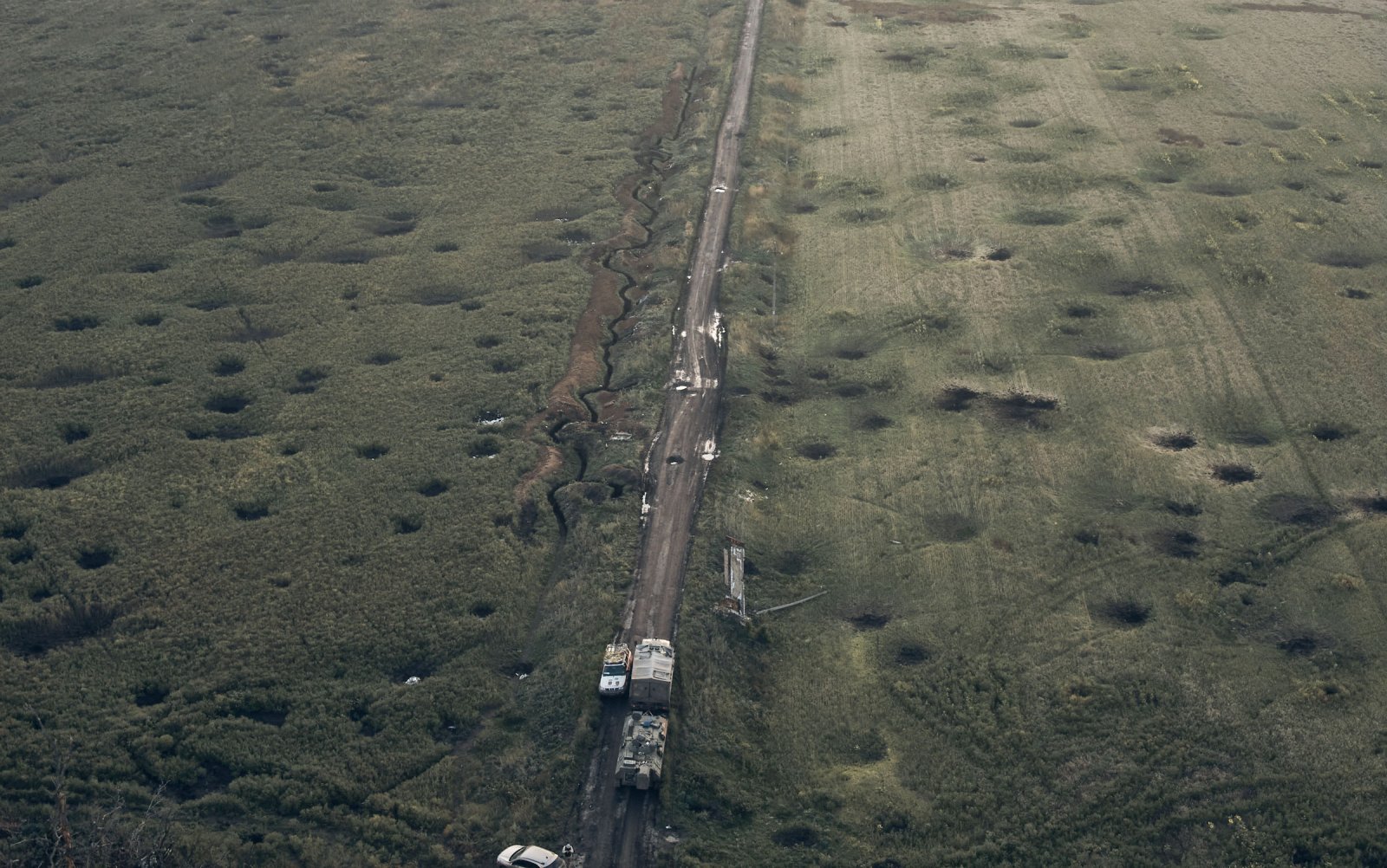 A field is covered with craters left by the shelling close to Izium, Kharkiv region, Ukraine, Tuesday, Sept. 13, 2022. Kostiantyn Liberov—AP