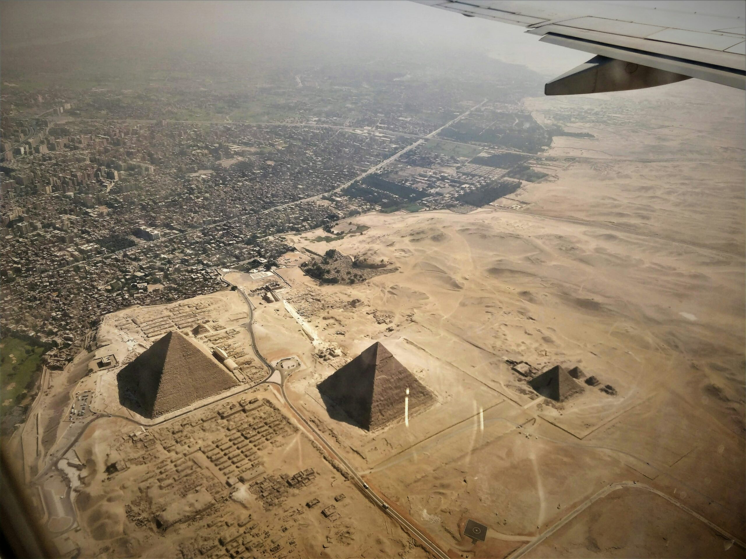 An ariel view of Giza Pyramids depicting how urban spurl is expanding aggressively and taking over both agricultural land and the desert surrounding the Pyramids  