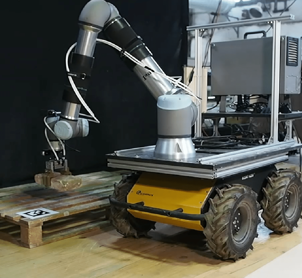 UR10E attahed to Husky rover placing bricks